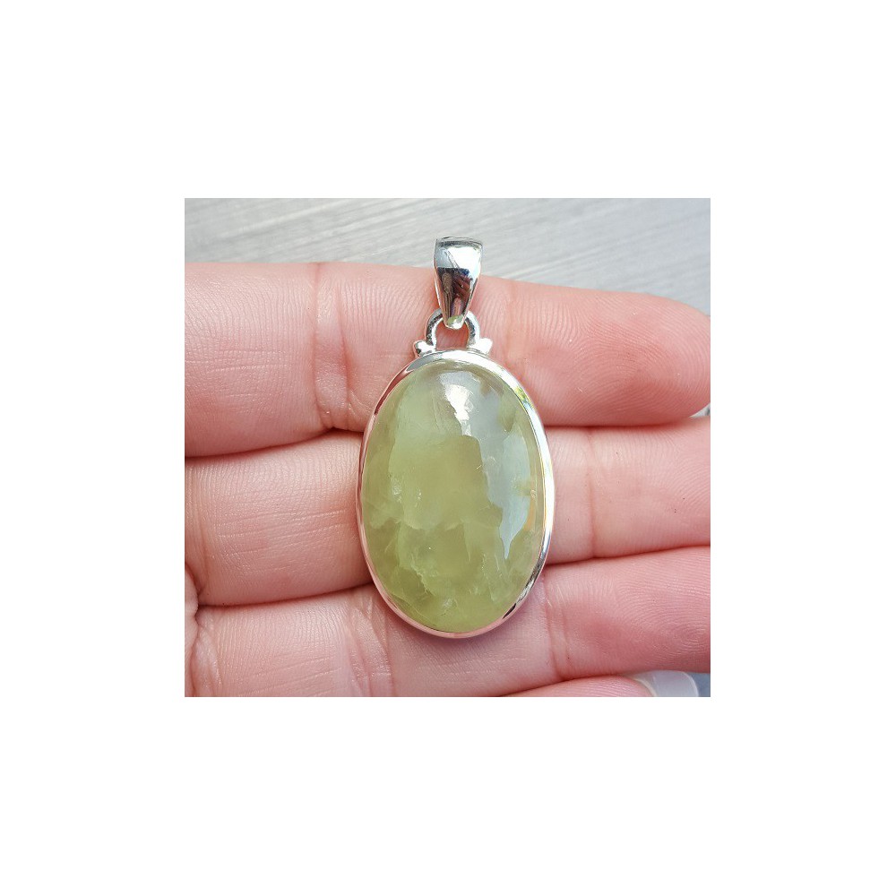 Silver pendant with oval cabochon its color