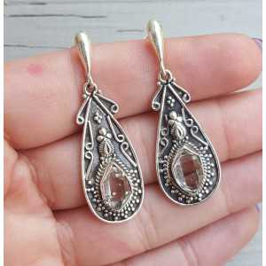 Silver earrings set with Herkimer Diamonds in a carved setting