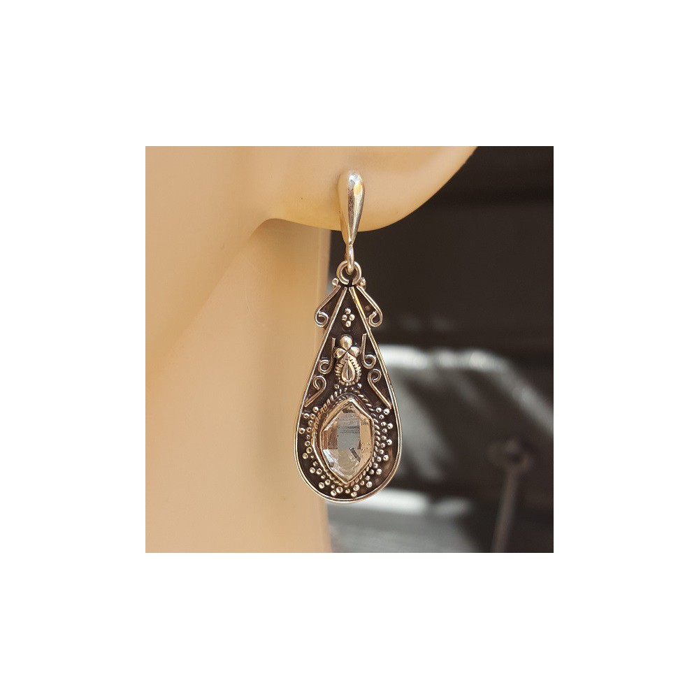 Silver earrings set with Herkimer Diamonds in a carved setting