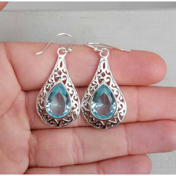 Silver earrings with blue Topaz in open worked setting 