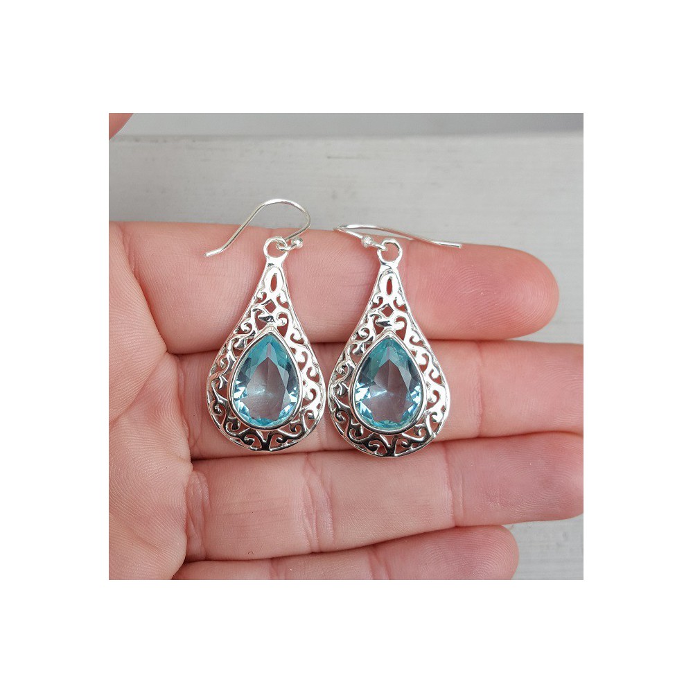 Silver earrings with blue Topaz in open worked setting 