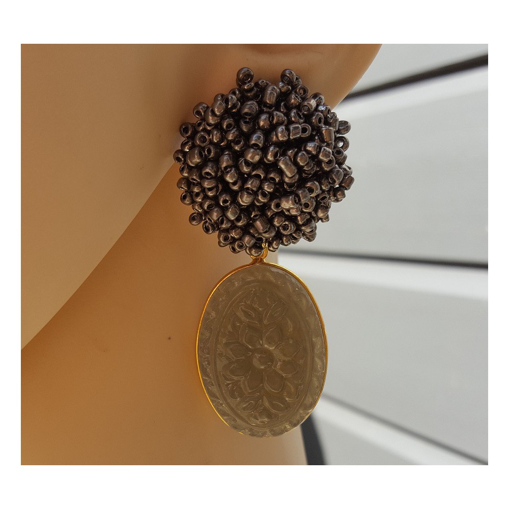 Gold plated earrings oorknoppen of beads and carved grey Chalcedony