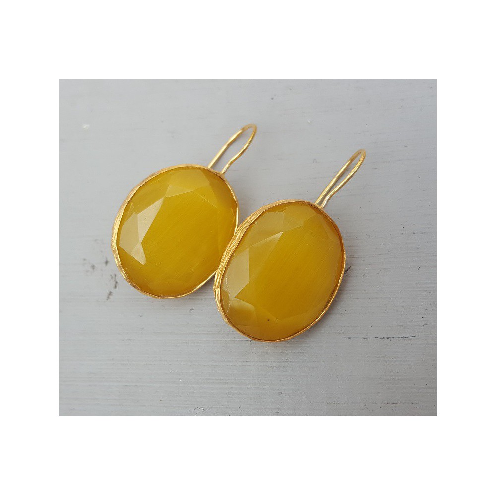 Gold plated earrings set with oval yellow cat's eye