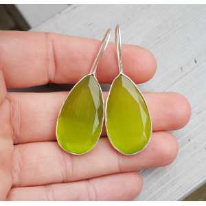 Silver earrings set with small oval green cats eye