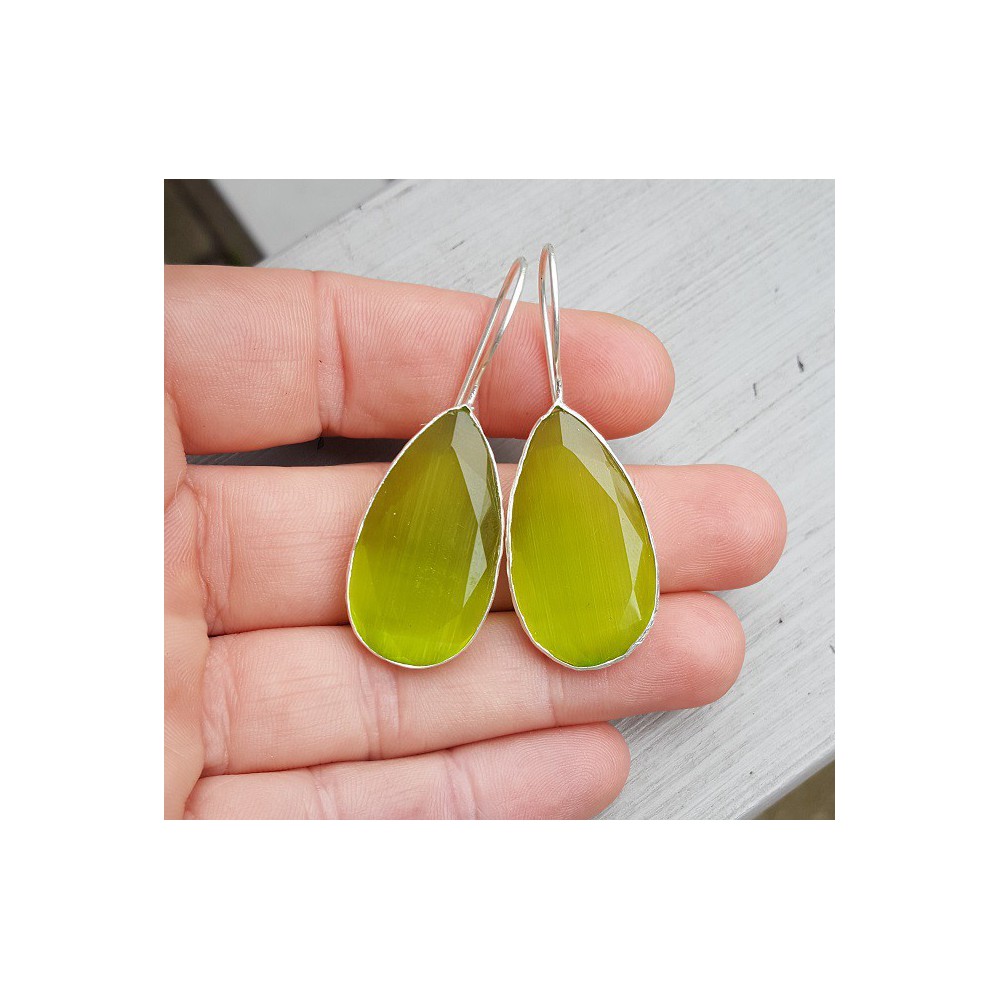 Silver earrings set with small oval green cats eye