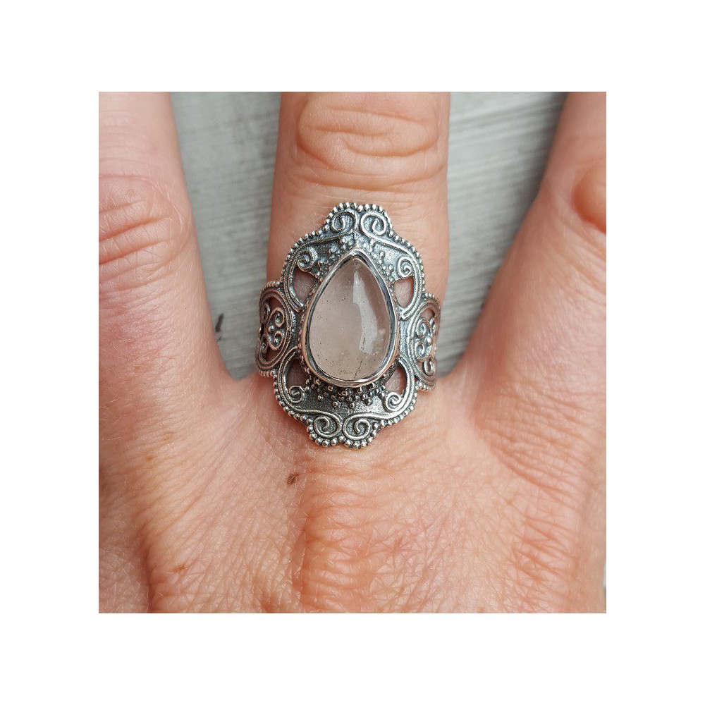 Silver ring set with rose quartz and carved head