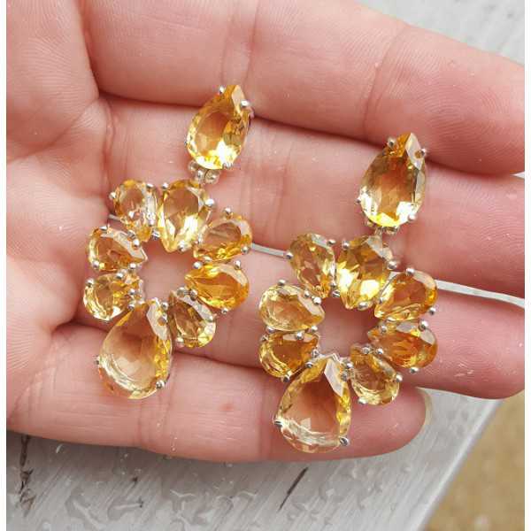 Silver earrings set with oval facet cut Citrine