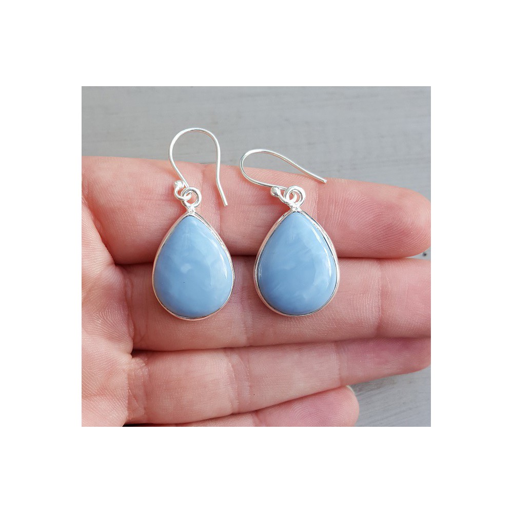 Silver earrings set with teardrop shaped blue Opal