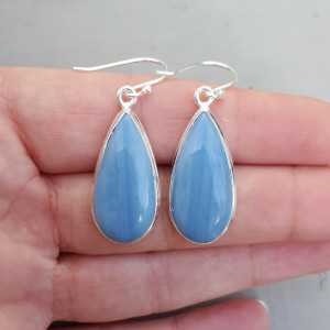 Silver earrings set with narrow teardrop shaped blue Opal