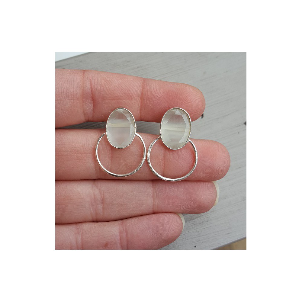 Silver earrings set with oval white cat's eye