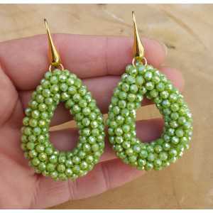 Gold plated earrings with open drop of green crystals