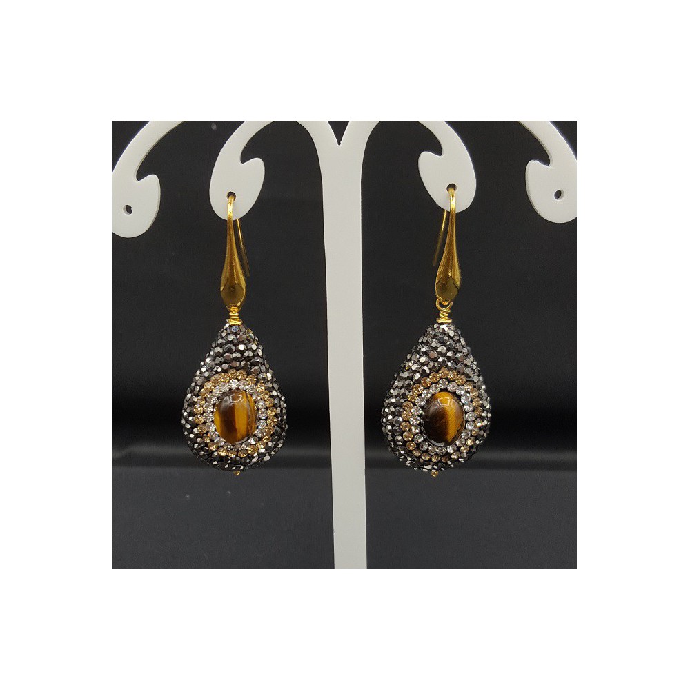 Earrings set with tiger's eye and black crystals