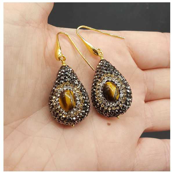Earrings set with tiger's eye and black crystals