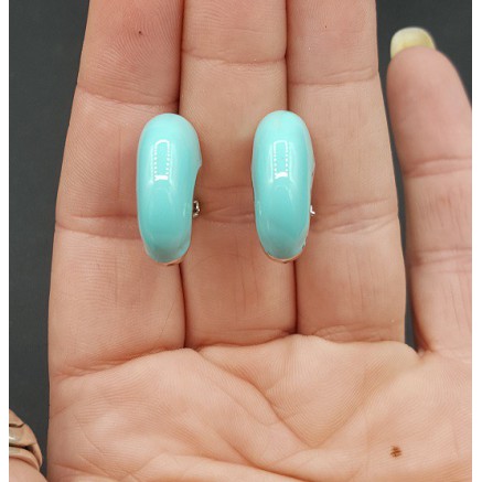 Brede zilverkleurige creolen turkoois blauw