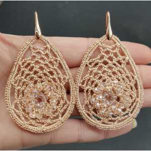 Earrings with salmon colored pendant of silk thread and crystals