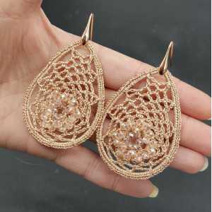 Earrings with salmon colored pendant of silk thread and crystals