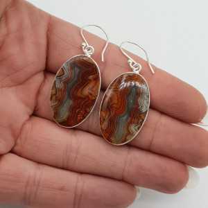 Silver earrings set with large oval Laguna Lace Agate