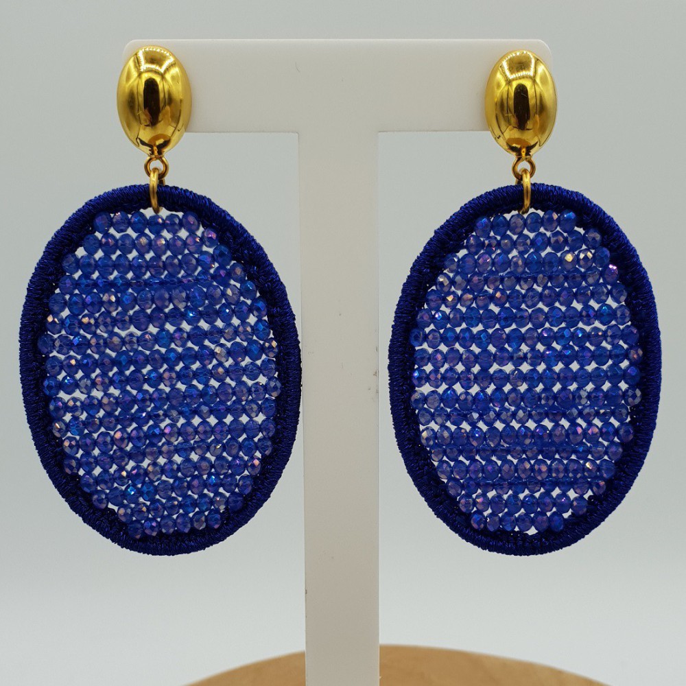 Earrings with oval pendant made of silk thread and blue crystals