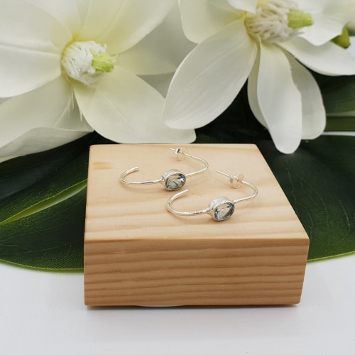 Zilveren creolen gezet met ovale blauw Topaas