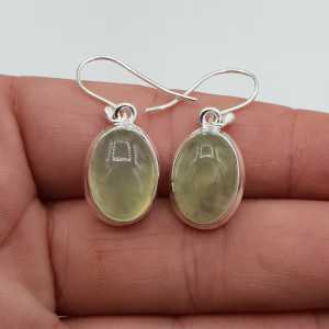 Silver earrings set with oval cabochon its color