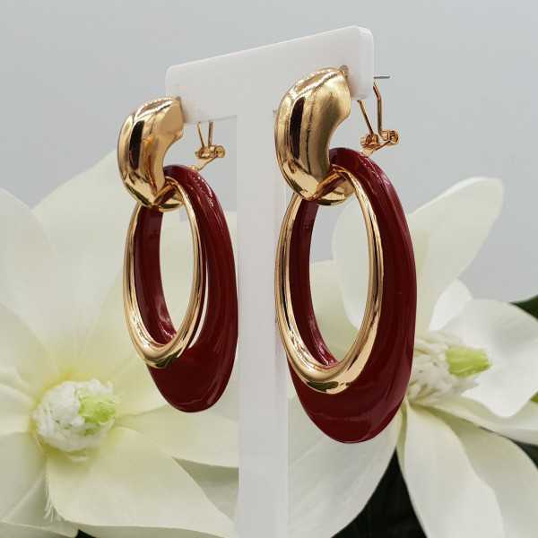 Gold creoles with red buffalo horn pendant