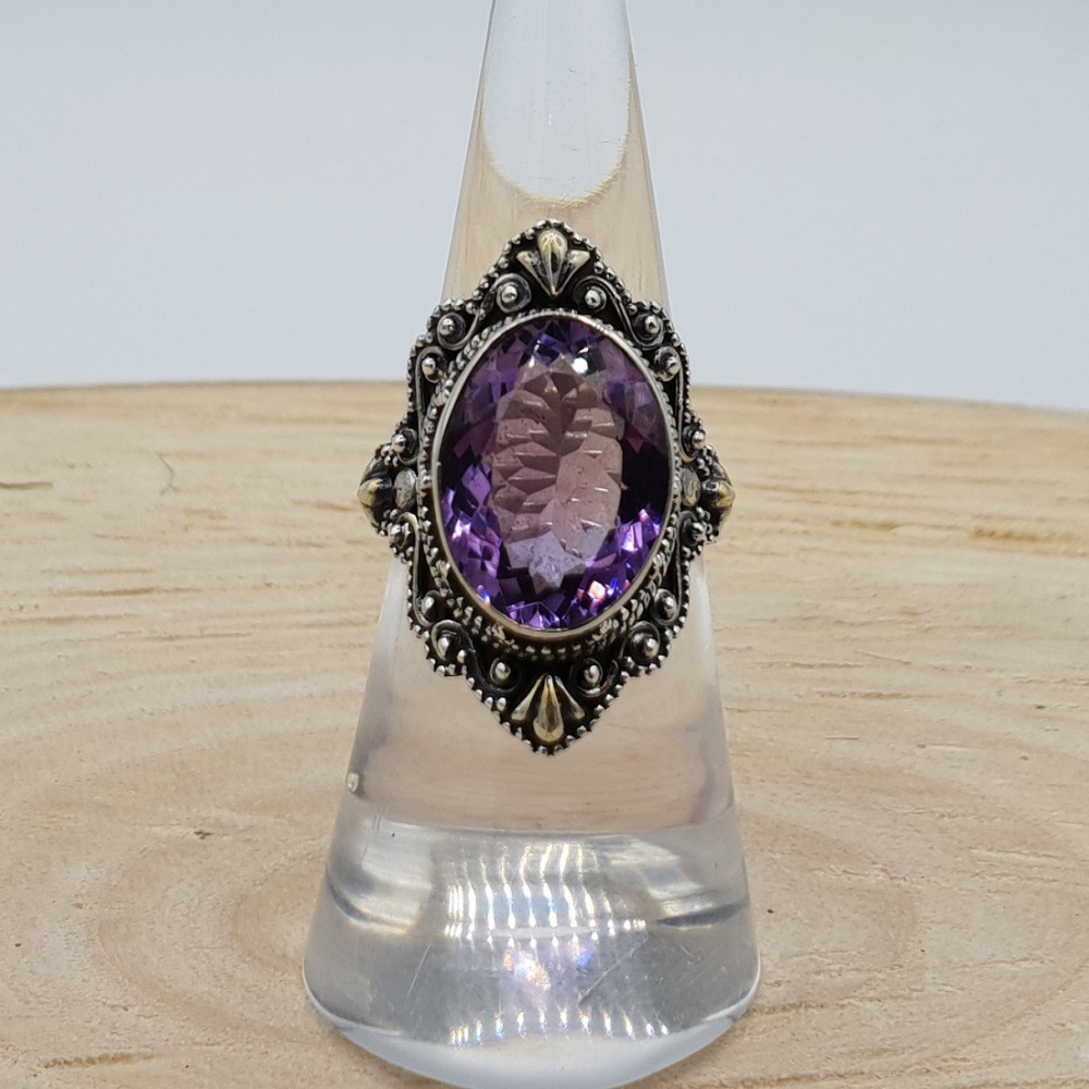 Silver ring with oval facet Amethyst and carved head