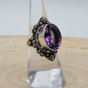 Silver ring with oval facet Amethyst and carved head