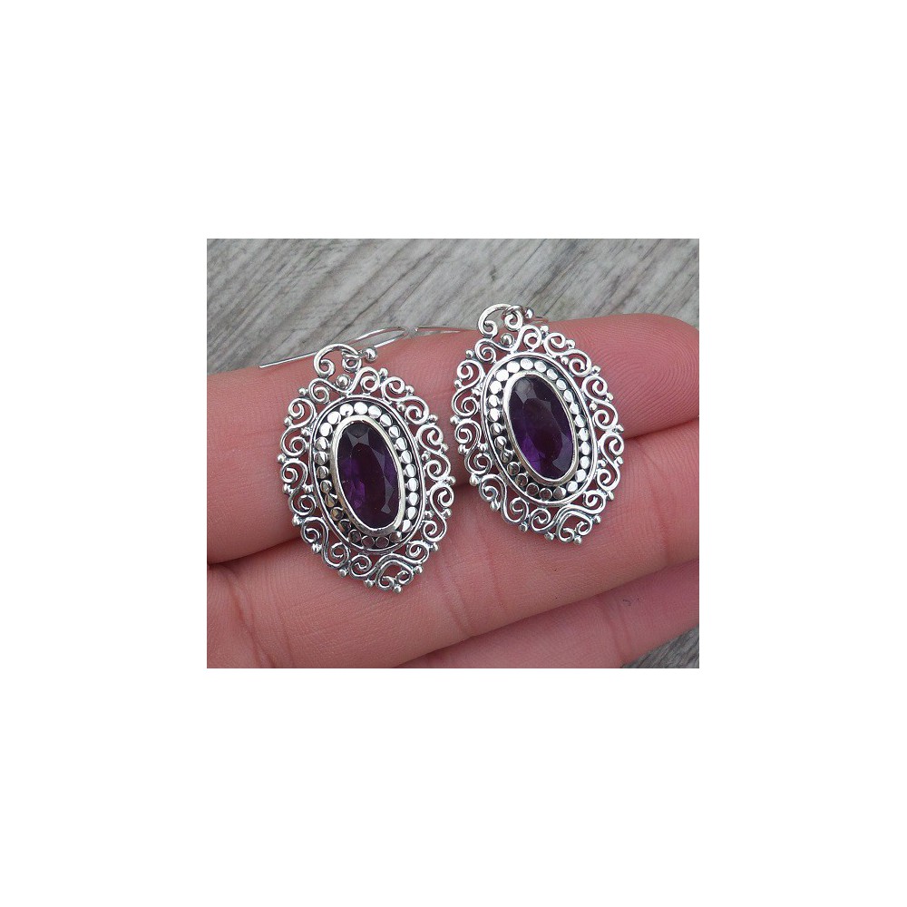 Silver earrings with oval faceted Amethyst in carved setting 