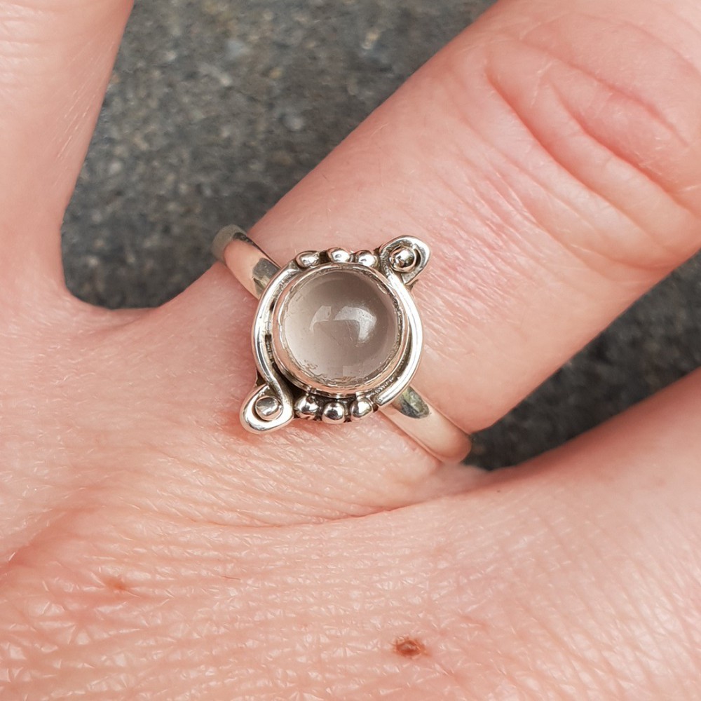 Silver ring set with a small round rose quartz