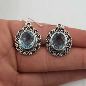 Silver earrings oval blue Topaz set in a carved setting