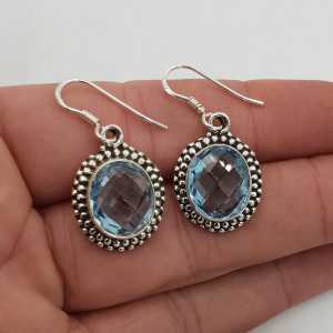 Silver gemstone earrings set with oval facet blue Topaz
