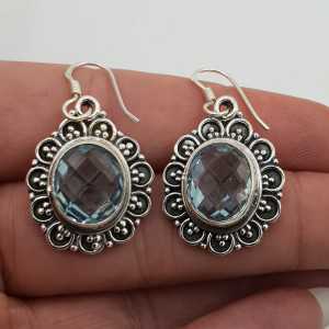 Silver earrings blue Topaz set in a carved setting
