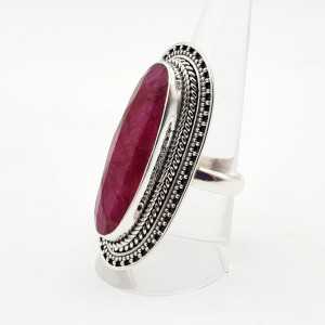 A silver ring set with a large oval shaped Ruby