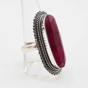 A silver ring set with an oval faceted Ruby in
