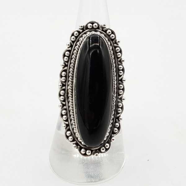 A silver ring set with black Onyx and a carved head