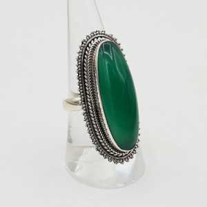 A silver ring set with oval green Onyx.