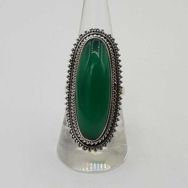 A silver ring set with oval green Onyx.