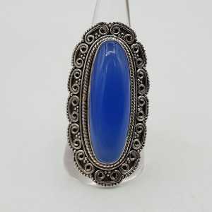 A silver ring with a blue Chalcedony, and carved heads