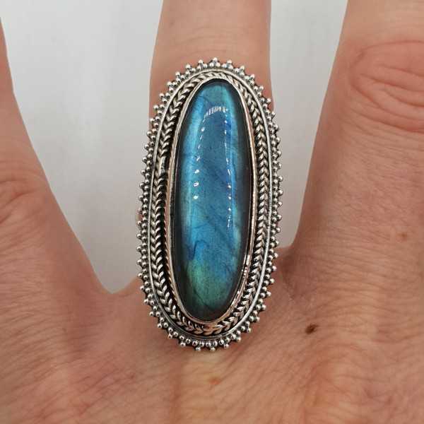 A silver ring set with an oval Labradorite