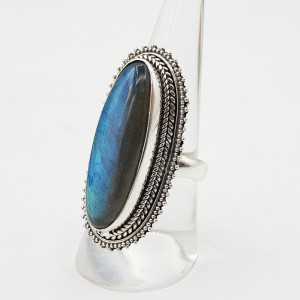 A silver ring set with an oval Labradorite