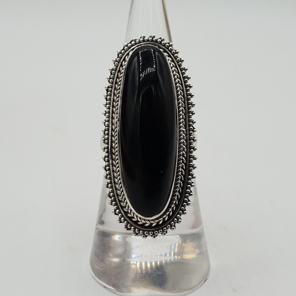 A silver ring set with an oval black Onyx.