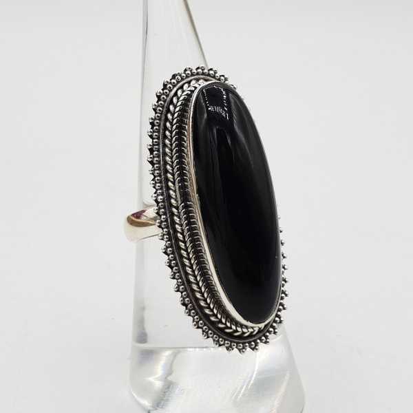 A silver ring set with an oval black Onyx.