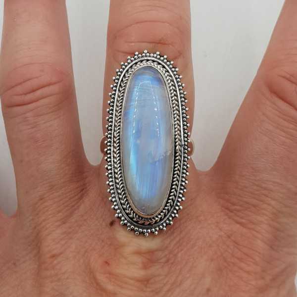 A silver ring set with an oval rainbow Moonstone