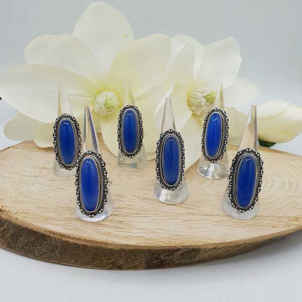 A silver ring set with blue Chalcedony as well as modified heads