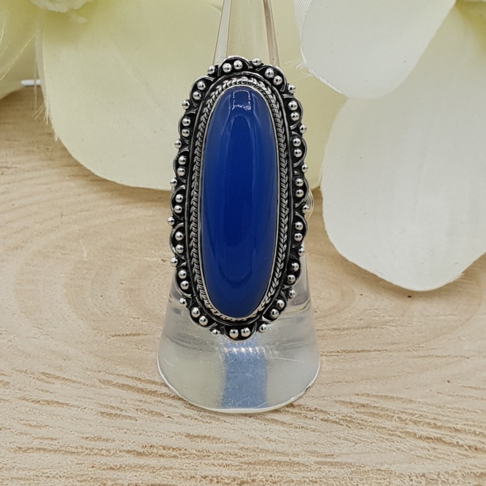 A silver ring set with blue Chalcedony as well as modified heads