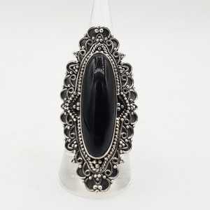 A silver ring with an oval-shaped black Onyx in any setting
