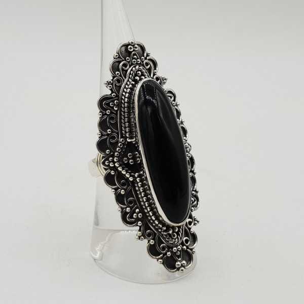 A silver ring with an oval-shaped black Onyx in any setting