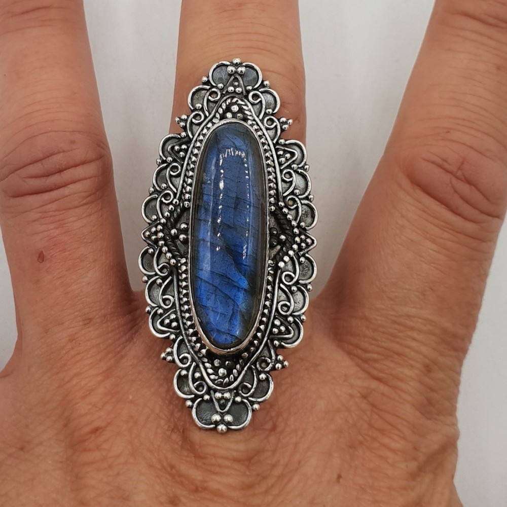 A silver ring with an oval Labradorite in any setting