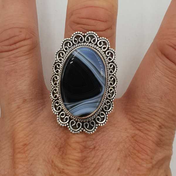 A silver ring with a black Botswana Agate stone and carved head, 20.5 mm