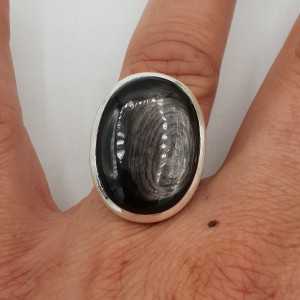A silver ring set with a Hypersteen 17.3 mm